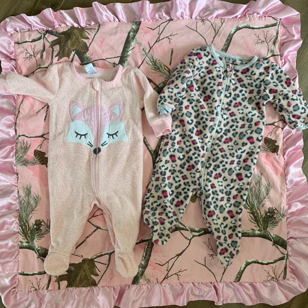Two baby girl sleepers and one blanket